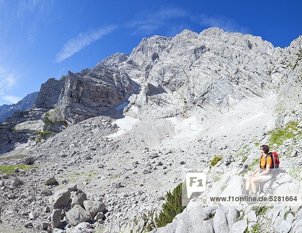 Female hiker having a break at the Hohe Goell Berchtesgaden Alps Austria