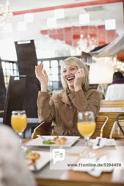 Businesswoman laughing at lunch