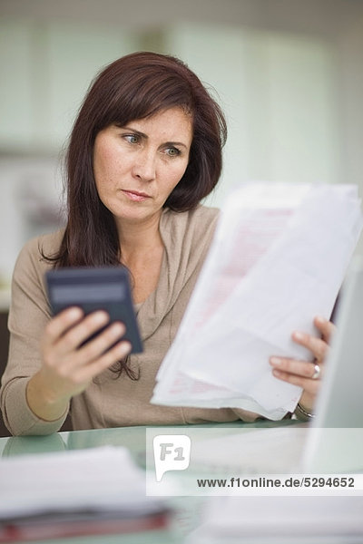Woman paying her bills at home