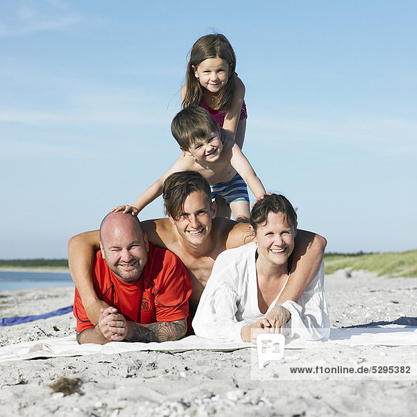 Family playing together on beach towel