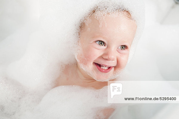 Toddler playing in bubble bath