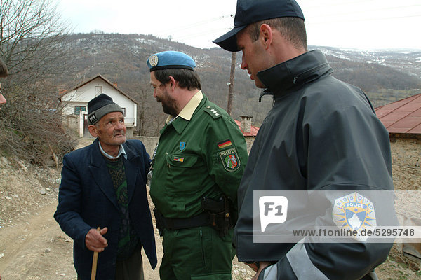 Indian  German and Kosovan police officers and a translator  international police patrol  the police operations are part of the United Nations Mission in Kosovo  UNMIK  in the village of Orcusa near the Albanian border  Kosovo  Europe