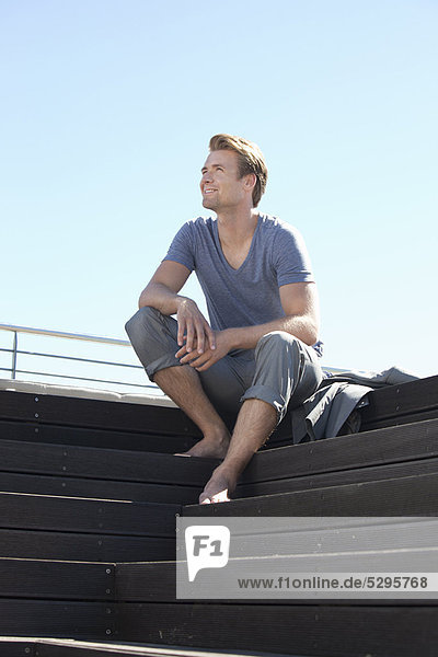 Man relaxing on wooden steps