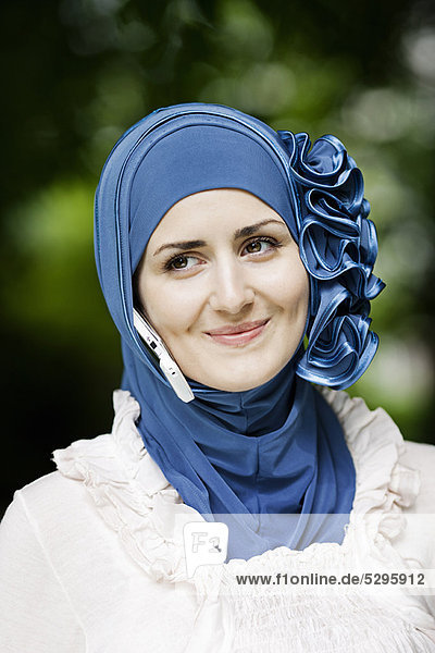 Woman with cell phone in headscarf
