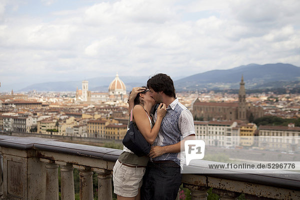 Couple kissing against the backdrop of Florence  Italy  Europe