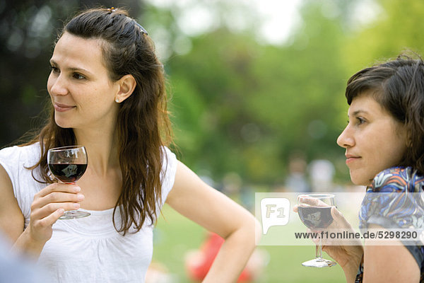 Women enjoying red wine outdoors