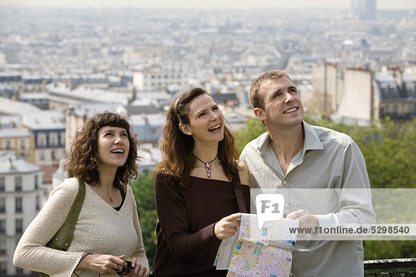 Tourists standing with map  looking up  Paris  France