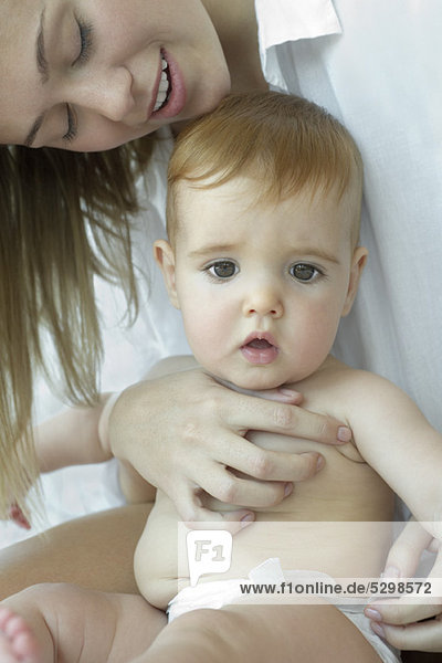 Infant sitting on mother's lap  portrait