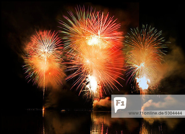 Aerial fireworks display on the lake  triple mushroom clouds with reflections  Schliersee Lake  Upper Bavaria  Bavaria  Germany  Europe