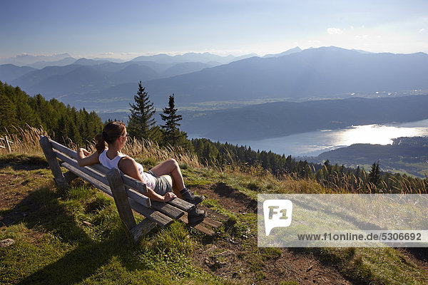 Female hiker overlooking Millstaettersee lake  Carinthia  Austria  Europe