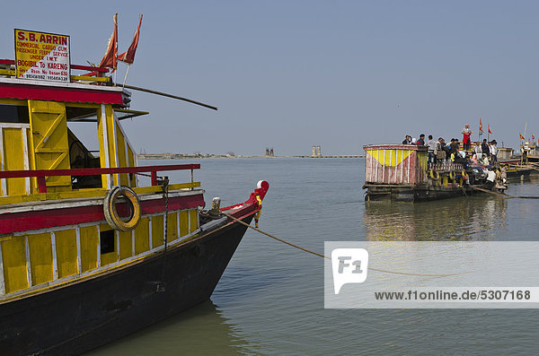 Ferryboats  waiting for customers to cross Brahmaputra River  Ghat  Assam  India  Asia