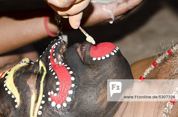 The make-up of the Kathakali character Nakrathundi is being applied  Varkala  Kerala  India  Asia