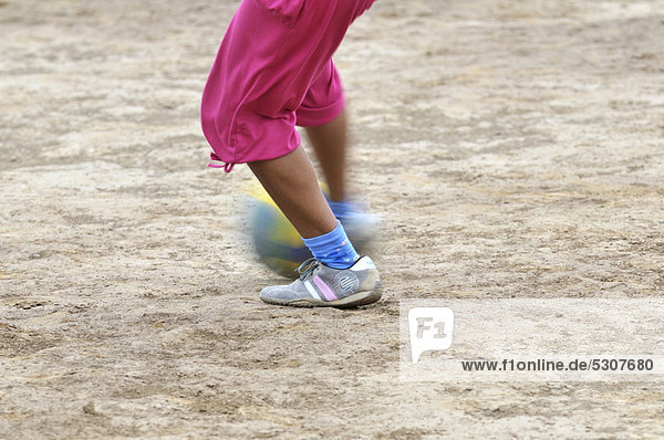 Girl playing soccer  detailed view of the feet with the ball  indigenous community of La Curvita  called Hothaj in the language of the Wichi Indians  Gran Chaco region  Salta province  Argentina  South America