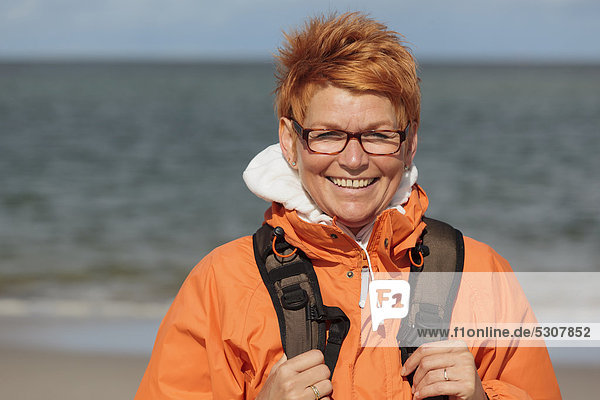 Smiling woman at the North Sea  island of Amrum  North Frisian Island  Schleswig-Holstein  Germany  Europe