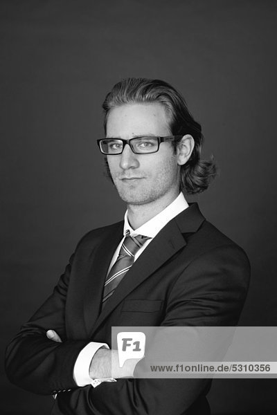 Young man wearing a business suit and glasses  portrait