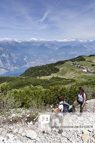 Climbers while ascending Monte Altissimo above Nago  looking towards Lake Garda and Arco  Trentino  Italy  Europe