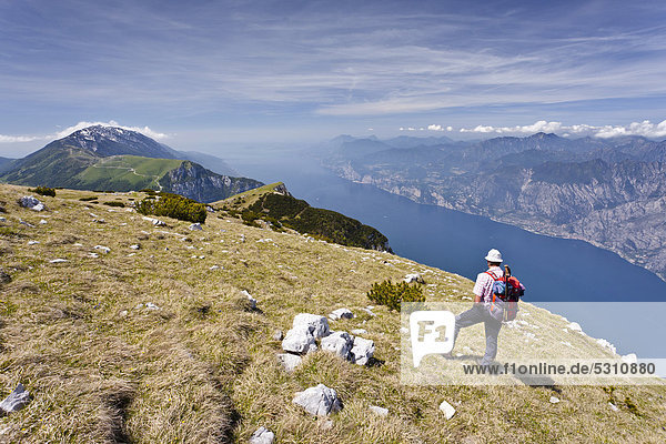Climber on Monte Altissimo above Nago  looking towards Lake Garda  with Monte Baldo at the rear  Trentino  Italy  Europe