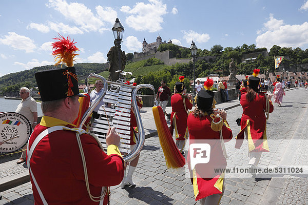 Parade in traditional costume during the Kiliani Festival  on Old Main bridge with Fortress Marienberg in the distance  Wuerzburg  Lower Franconia  Franconia  Bavaria  Germany  Europe  PublicGround