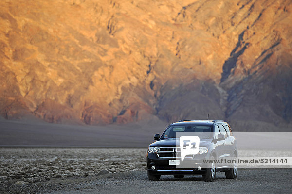 Dodge Durango SUV on a dirt track  Devil's Golf Course  Death Valley National Park  evening light  Mojave Desert  California  United States of America  USA