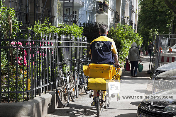 Postman on a bicycle in the Eppendorf district  Hamburg  Germany  Europe