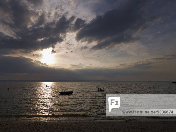 Sunset on Lake Neusiedler See with children playing in the water  Burgenland  Austria  Europe