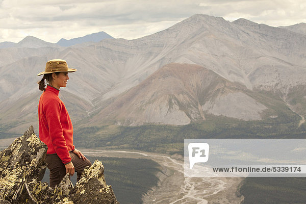 Young woman hiking  enjoying panorama view  Wind River Valley  Northern Mackenzie Mountains  Yukon Territory  Canada
