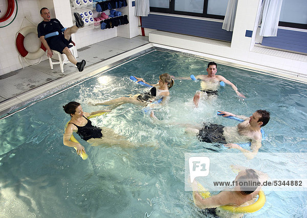 Patients doing aqua aerobics  water aerobics  exercise therapy  physiotherapy in water  e.g. as a rehabilitation program  in a hospital in Germany  Europe