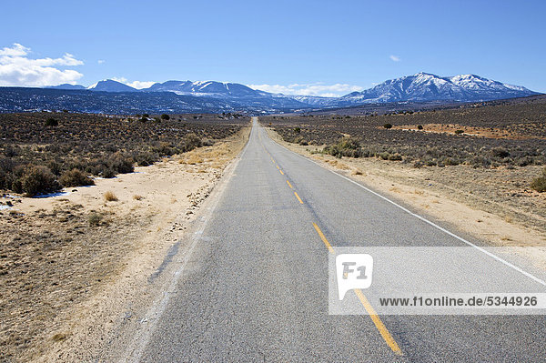 Utah Highway 211 looking towards La Sal Mountains just outside of Canyonlands National Park Utah USA America
