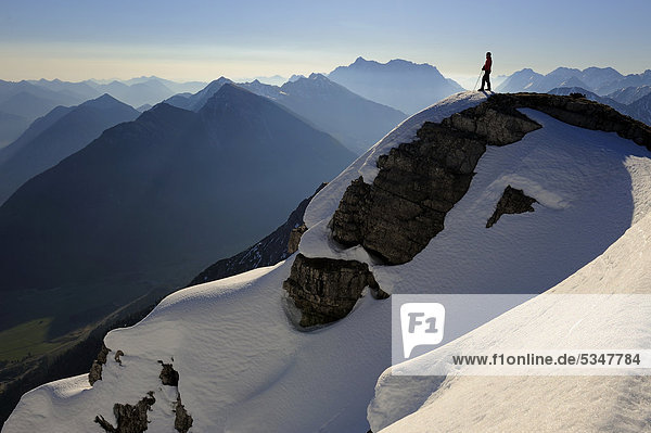 Wintery summit with climber in the early morning  Rutte  Ausserfern  Tyrol  Austria  Europe