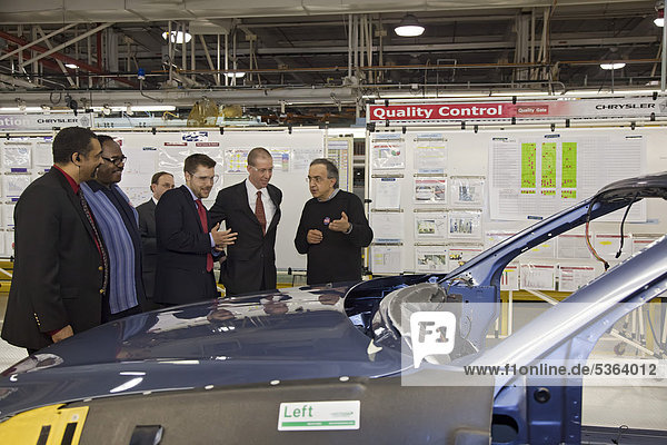 Chrysler marked the repayment of $7.6 billion in loans from the U.S.  Canadian  and Ontario governments with a celebration at the company's Sterling Heights Assembly Plant  Chrysler CEO Sergio Marchionne  right  leads a tour of the assembly line  next to him is Ron Bloom  assistant to President Obama for Manufacturing Policy  Sterling Heights  Michigan  USA