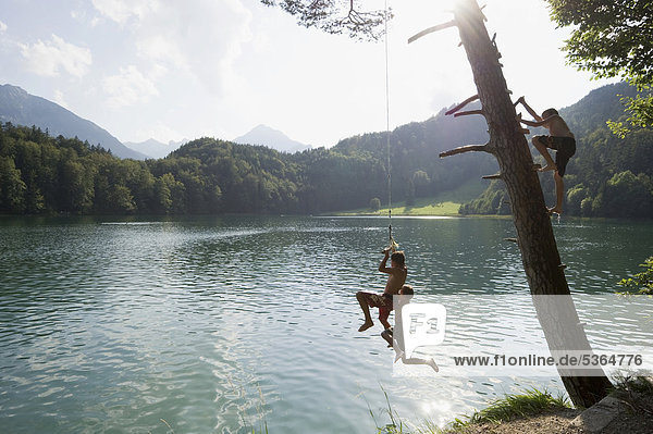 Children having fun on Lake Alatsee near Fuessen  Allgaeu region  Bavaria  Germany  Europe