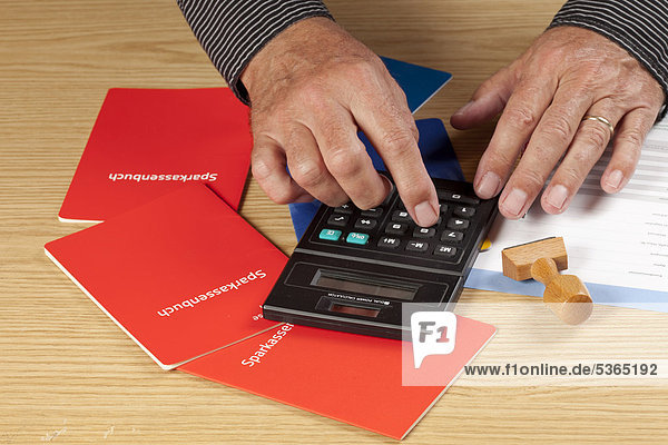 Hands of a senior using a calculator  savings accounts