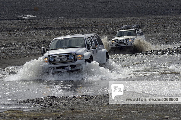 Super-Jeeps beim Furten eines Seitenarmes des Flusses Kross·  _Ûrsmörk  Island  Europa