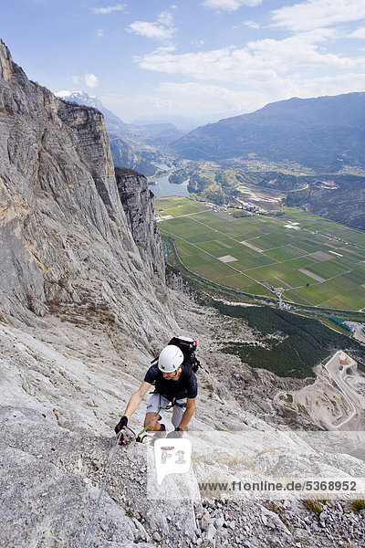 Mountain climber climbing the Che Guevara Climbing Route on the Monte Casale in Sarca Valley  Lake Garda region  looking towards Lake Toblino  Trentino  Italy  Europe