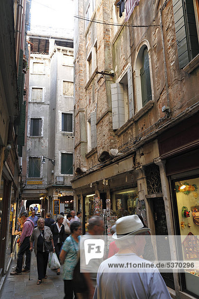 Shoppers and tourists in a narrow street  Venice  Italy  Europe