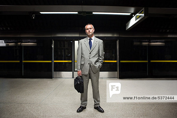 Businessman waiting on subway platform