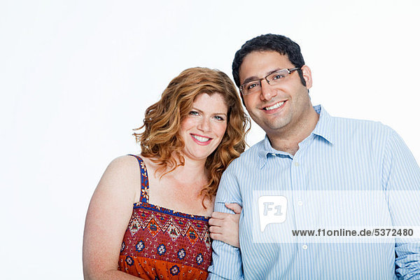 Couple smiling against white background