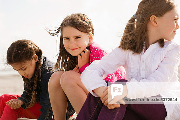 Mädchen am Strand sitzen
