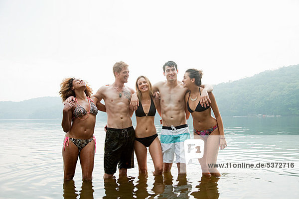 Portrait of friends standing in lake