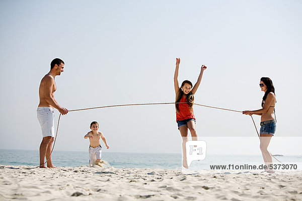 Family holding running competition on a beach