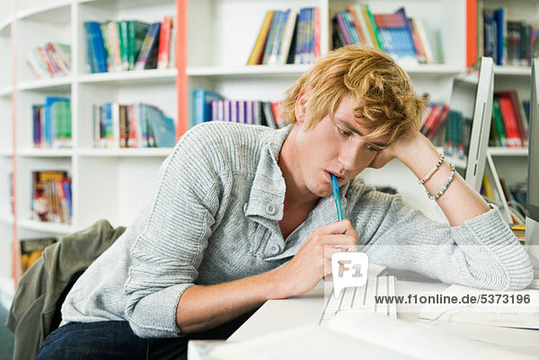 University student leaning on desk