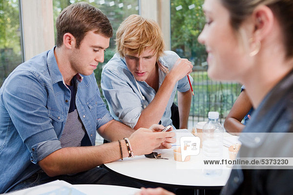 University students texting in college cafe