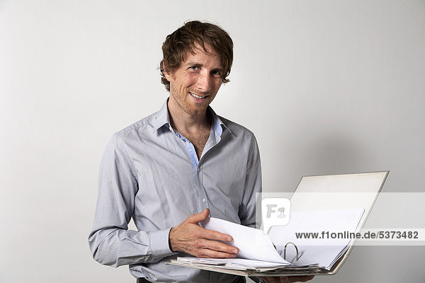 Man searching information from file  smiling  portrait
