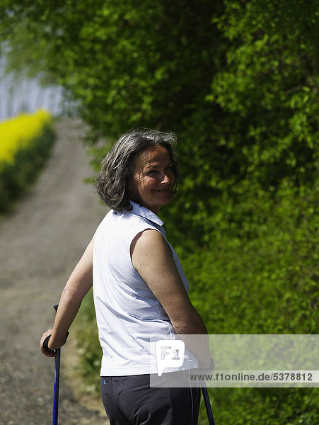 Germany  Mature woman nordic walking  smiling  portrait