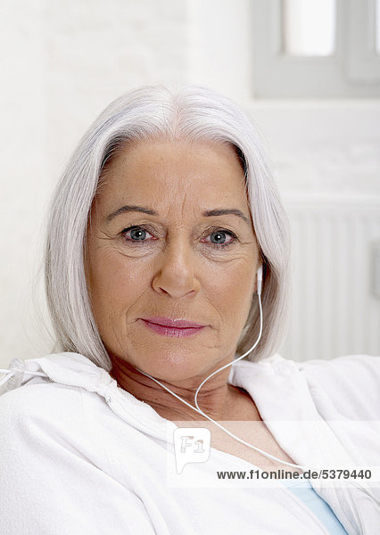 Senior woman listening music  portrait
