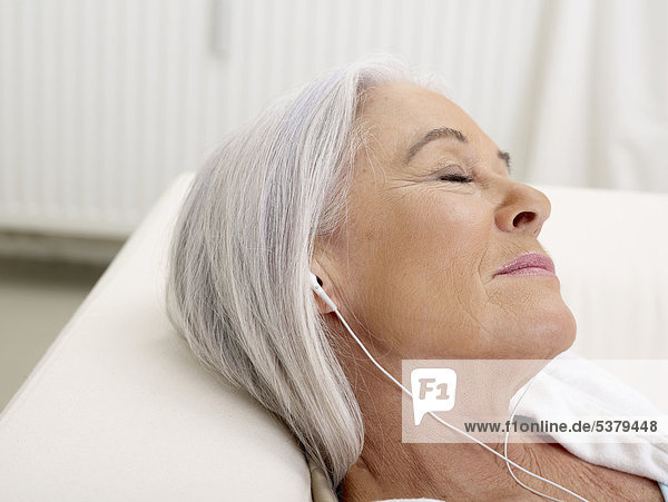 Senior woman listening music