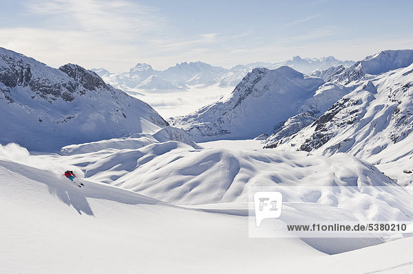 Austria  Zurs  Lech  Young woman doing alpine skiing on Arlberg mountain
