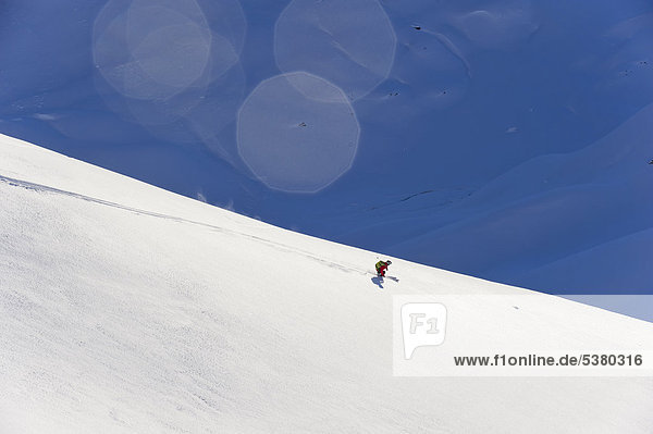 Austria  Zuers  Young man doing telemark skiing on Arlberg mountain