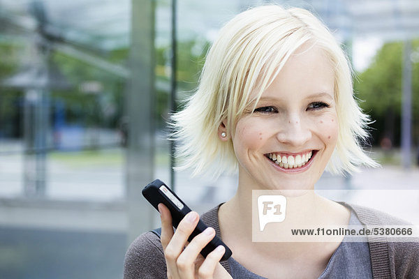 Young woman with cell phone  smiling