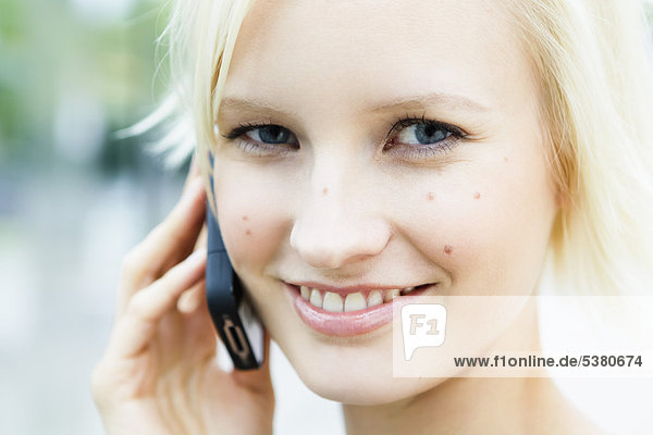 Young woman on phone  smiling  portrait